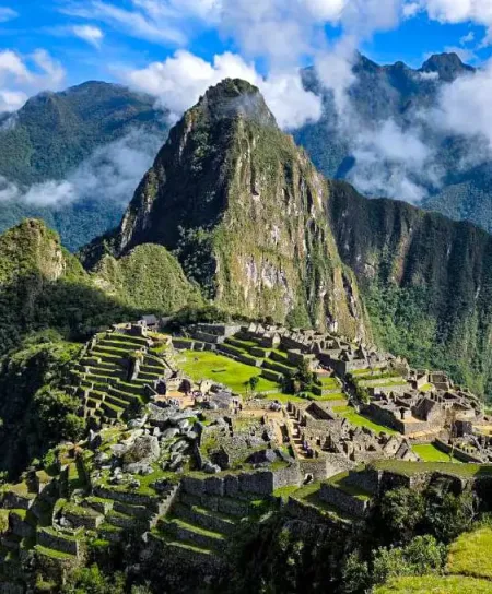 The Majestic Lost City of the Incas Full overhead view of the Machu Picchu archaeological site, showing the iconic peak and the complex of stone buildings.